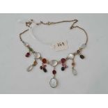 A ANTIQUE EDWARDIAN MOON STONE AND MULTI STONE NECKLACE SET WITH GARNETS PERIDOTS TOURMALINES AND