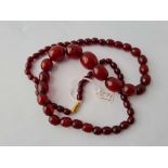 A string of cherry amber beads - 66 gms