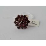 A large flower head garnet cluster ring in 9ct mount size N 6.5g inc