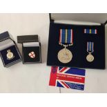 A boxed National Service medal with miniatures & 2 badges