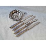 A set of four enamel decorated silver handled knives and a leaf shaped dish