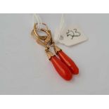 A pair of 9ct and coral torpedo shaped earrings