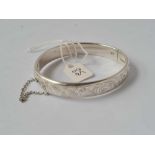 A good chased silver bangle by Charles Horner