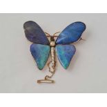 A attractive butterfly brooch with peridot and ruby and pearl body and four opal panel wings in