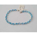 A white gold and blue topaz line bracelet 7 inches - 5.2 gms