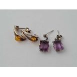 A pair of silver and purple stone earrings