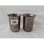 A pair of continental silver beakers, engraved with flower heads - 3.75" high - 115 g.