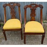 A set of six French Empire style chairs with carved backs and sabre legs