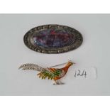 An unusual Arts & crafts brooch and an enamelled pheasant brooch