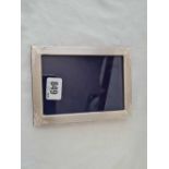 An oblong photo frame - 6" high with import mark