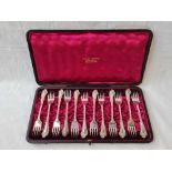 A box set of twelve late Victorian cake forks, decorated with scrolls, B'ham 1894 by Martin Hall &