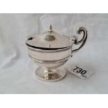 A circular mustard pot with scroll handle with B.G.L, B'ham 1910, 75g net