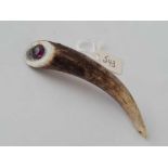 A Scottish horn brooch mounted with a purple stone