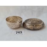 An oval Eastern silver snuff box with hinged cover - 3" wide - and a small bowl - 80 g.