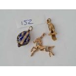 A silver and enamel fob in the form of a egg plus two 9ct charms in the form of a eagle and a