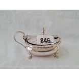 An oval mustard pot on four claw feet - 3.75" wide - Birmingham 1919 - 76 g. excluding BGL