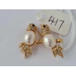 A pretty pair of cooing doves brooch with gem set neck and eyes and pearl body sitting on a branch