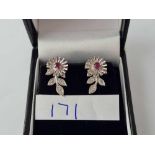 A attractive ruby and diamond earrings in the form of a flower boxed 9ct