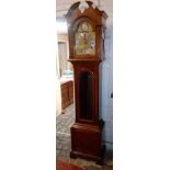 Another chiming long case clock in mahogany case with glazed door. 7' high.