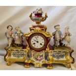 A decorative French porcelain mantle clock with 2 pairs of figures and white enamel dial. 17" wide.