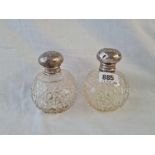 A pair of scent bottles embossed with cherubs and cut glass bodies - Birmingham 1907 by S.B