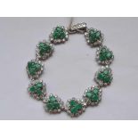 A decorative silver green and white stone bracelet