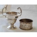 A scroll engraved napkin ring and a small two handled trophy - 53 g.