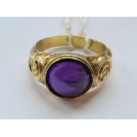 A Georgian gold cased embossed ring foil back set with cabochon amethyst A/F size Q - 4 gms