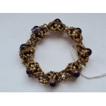 A fancy silver gilt bracelet set with purple cabochon stones
