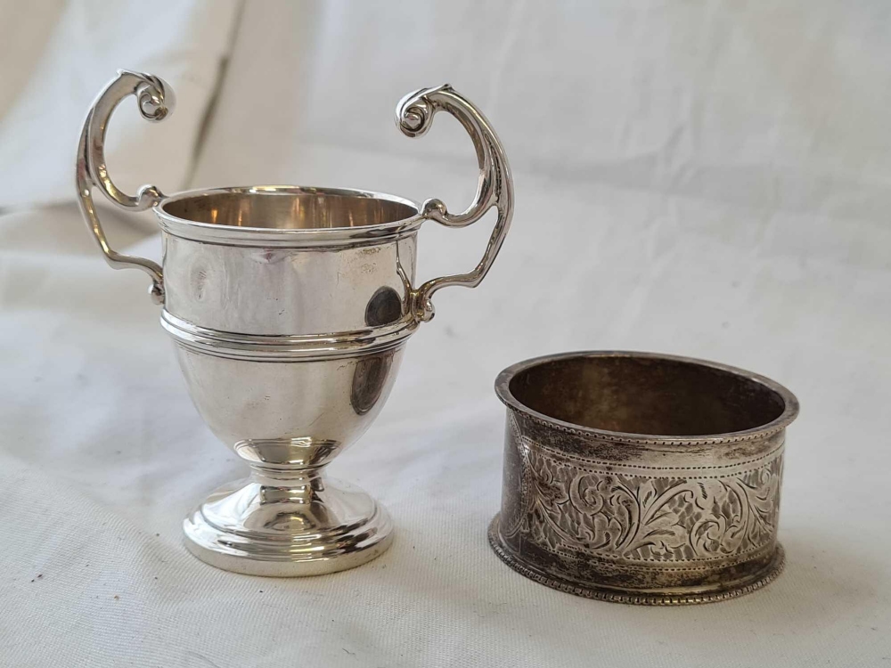 A scroll engraved napkin ring and a small two handled trophy - 53 g. - Image 2 of 2
