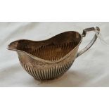 An oval Victorian half-fluted cream jug – 4” wide – Birmingham 1898