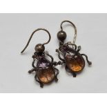 A pair of silver stone set bug earrings