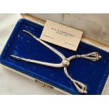 A boxed pair of Danish tongs with decorated handles - by Soresen
