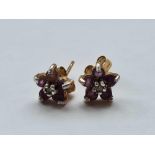 A pair of diamond and amethyst ear studs