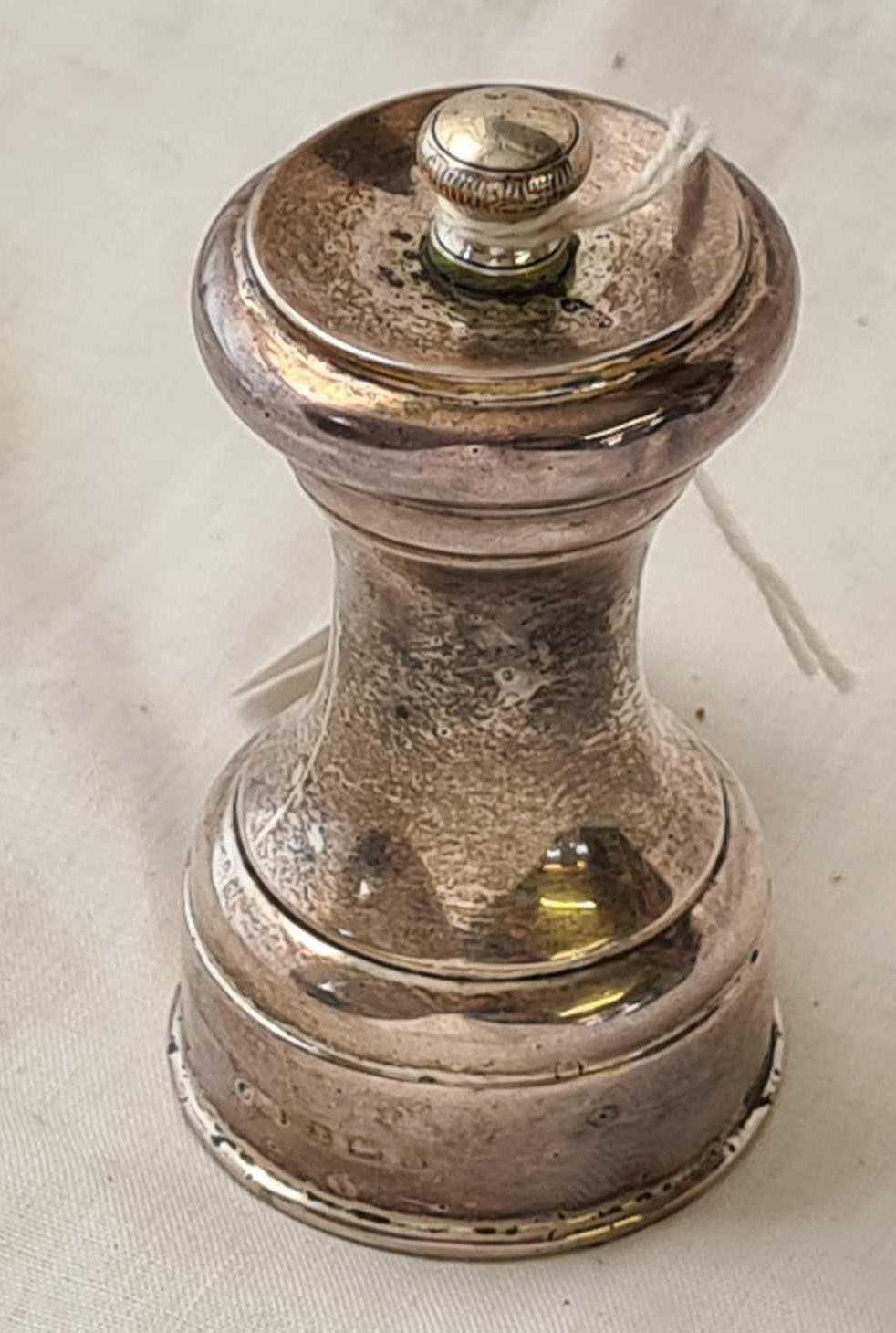 A pepper mill with concave shaped body - 3" high - by JG & S