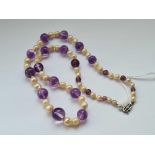 A amethyst and pearl necklace with 9c white gold clasp - 35 gms