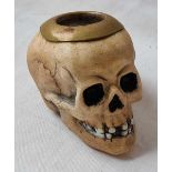 A vesta sricker with porcelain body in the form of a skull - 3.5" wide