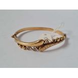 A 9ct vintage stylized snake design bangle with chased and bead decoration hallmarked B'ham 1968