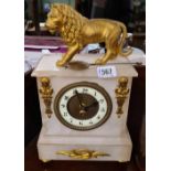 A Victorian white alabaster clock surmounted with a lion