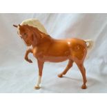 A Beswick figure of a prancing horse - 7" high