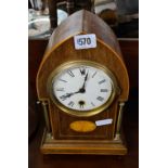 An Edwardian inlaid mahogany mantle clock with brass pillars