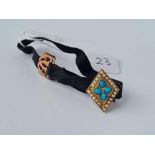 A black ribbon bracelet with gold turquoise & pearl panel
