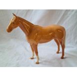 A Beswick figure of a standing horse - 8" high