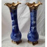 A pair of Art Nouveau Royal Doulton corolilanware vases painted with flowers - 14" high