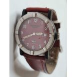 A Raymond Weil gents red faced wrist watch with calendar aperture