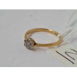 A circular diamond cluster ring 18ct gold size M1/2