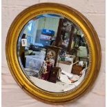 A circular 19th Century gilt framed mirror - 16" wide