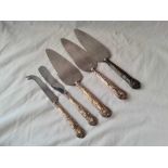 Three silver handled pie servers and two similar cheese knives