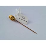 A 15ct gold stick pin set with a garnet