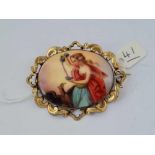 A large Victorian porcelain and yellow metal brooch with a classical scene